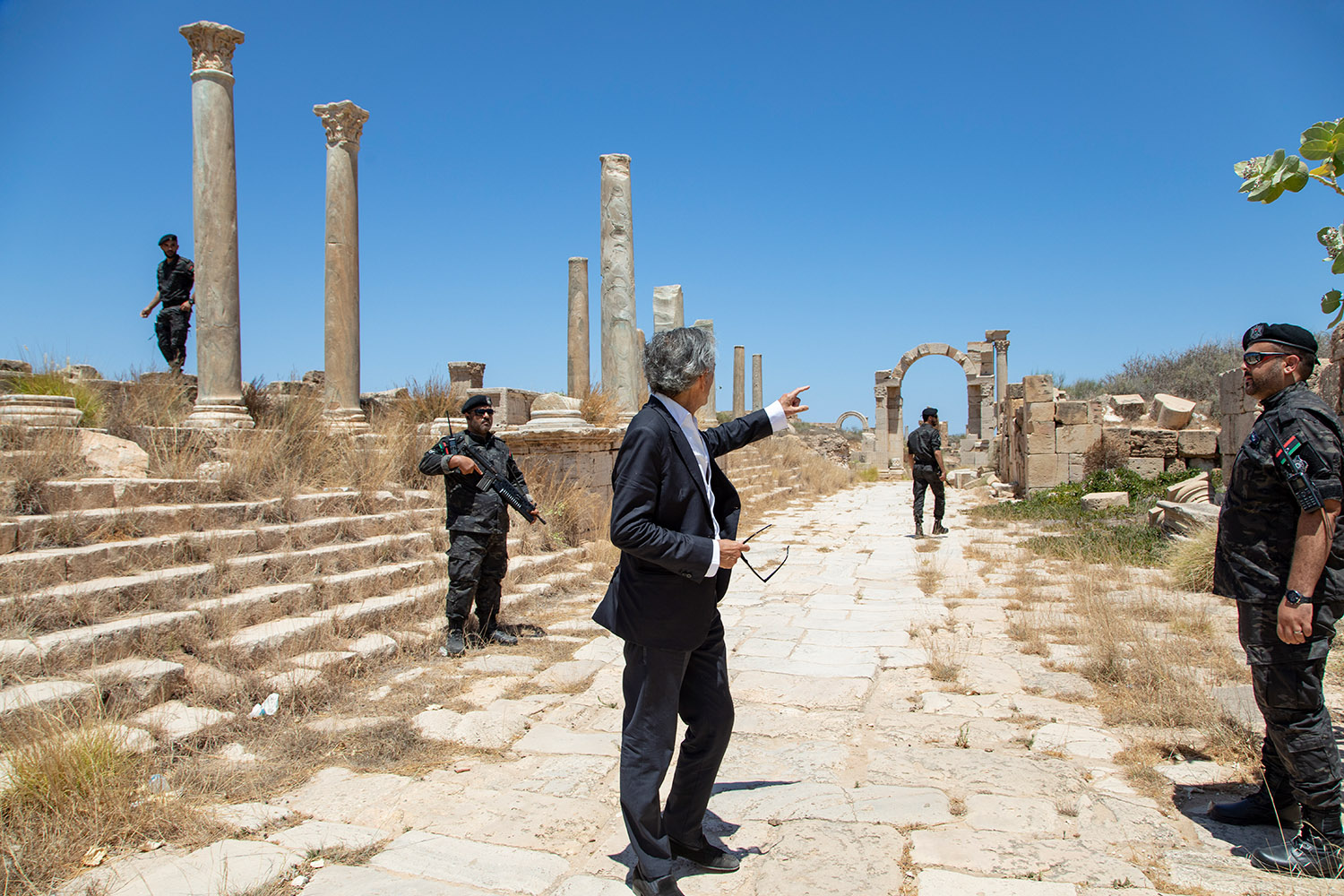 Bernard-Henri Lévy escorté dans les ruines de la cité antique de Leptis Magna.