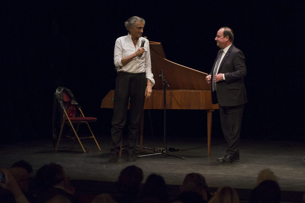 Bernard-Henri Lévy accueille François Hollande sur la scène du Théâtre Antoine lors meeting de solidarité avec le peuple ukrainien organisé par « La Règle du Jeu » le 1er mars 2022.