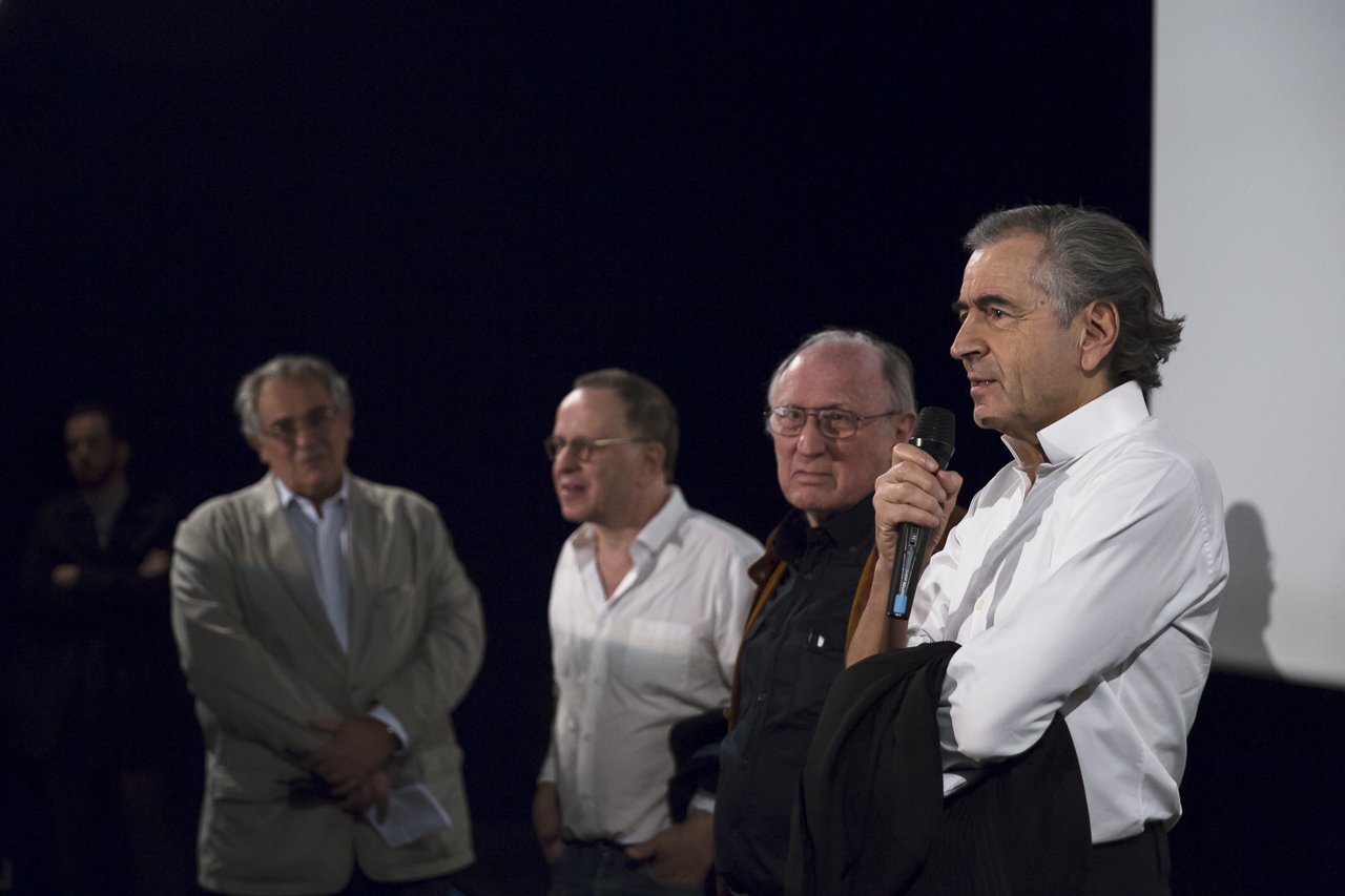 Bernard-Henri Lévy parle dans un micro sous le regard de Jean-Jacques Moscovitz, François Margolin et Fred Siksou.