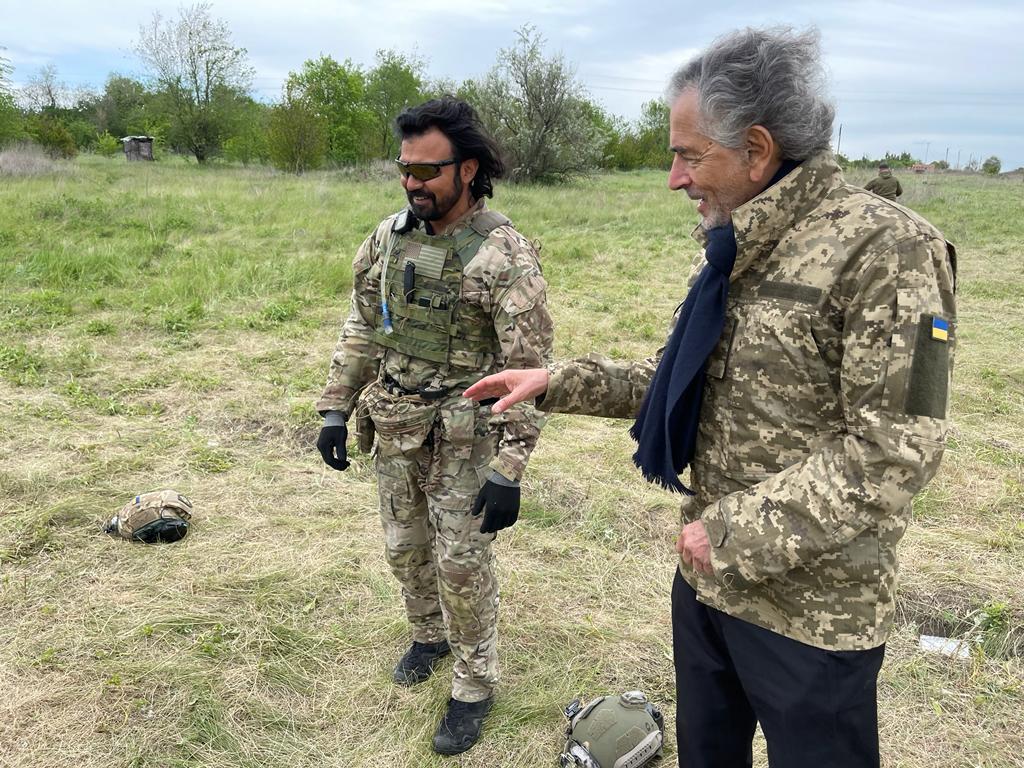Bernard-Henri Lévy chatting with a member of the Mozart Group in April 2022.
